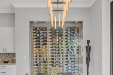 Inspiration for a contemporary wine cellar remodel in Miami with display racks