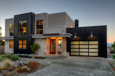 Design ideas for a beach style two-storey exterior in Seattle with wood siding and a flat roof.