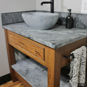 Warm wood cabinetry with a stone-look countertop and matte black accents.