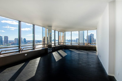 Inspiration for a large contemporary enclosed laminate floor and black floor living room remodel in New York with white walls