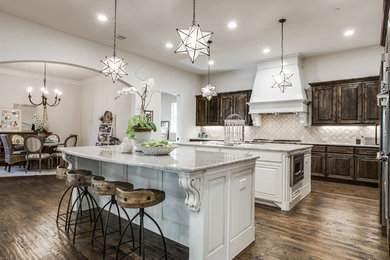Open concept kitchen - large mediterranean l-shaped dark wood floor open concept kitchen idea in Dallas with a double-bowl sink, white cabinets, granite countertops, beige backsplash, stone tile backsplash, paneled appliances and two islands