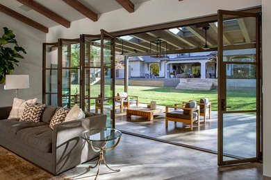 Inspiration for a mediterranean concrete back porch remodel in Austin with a roof extension