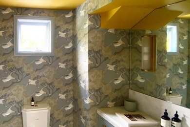 This is an example of a bathroom in Melbourne with wallpaper.