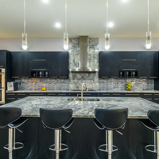 Huge modern kitchen pantry ideas - Huge minimalist single-wall ceramic floor kitchen pantry photo in Charleston with a double-bowl sink, flat-panel cabinets, black cabinets, marble countertops, gray backsplash, glass tile backsplash, stainless steel appliances and an island