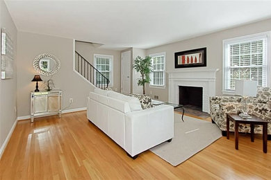 Living room - mid-sized traditional enclosed light wood floor living room idea in DC Metro with gray walls, a standard fireplace and a brick fireplace
