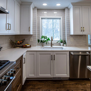 Two Tone Kitchen with Floating Shelves and Island Seating and Updated Fireplace