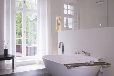 Mid-sized contemporary bathroom in Cologne with dark wood cabinets, a freestanding tub, a curbless shower, a wall-mount toilet, beige tile, limestone, beige walls, dark hardwood floors, a vessel sink, solid surface benchtops, brown floor, an open shower and brown benchtops.