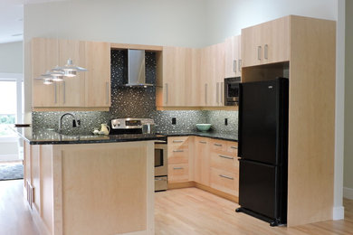 Mid-sized trendy u-shaped light wood floor open concept kitchen photo in Vancouver with an undermount sink, flat-panel cabinets, light wood cabinets, quartz countertops, black backsplash, mosaic tile backsplash and black appliances