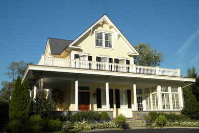 Large ornate yellow three-story wood gable roof photo in DC Metro