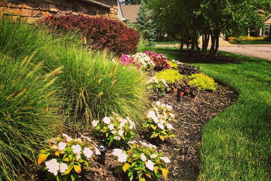 Photo of a large traditional full sun backyard stone landscaping in Cleveland.