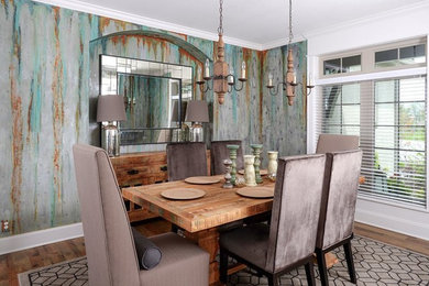 Inspiration for a mid-sized industrial medium tone wood floor kitchen/dining room combo remodel in Kansas City with multicolored walls