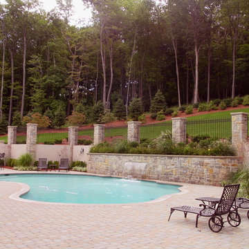 Custom pool with sheet flow waterfall, paver decking