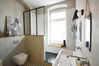 Mid-sized industrial 3/4 bathroom in Berlin with an open shower, multi-coloured tile, cement tile, grey walls and a vessel sink.