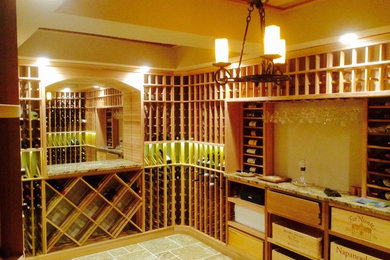 Inspiration for a large mediterranean ceramic tile wine cellar remodel in Other with storage racks