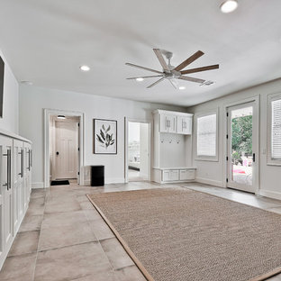 Large classic walk-out basement in Other with white walls, porcelain flooring and blue floors.