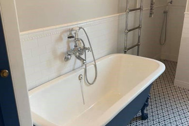 Photo of a medium sized victorian family bathroom in Berkshire with a claw-foot bath, an alcove shower, white tiles, beige walls, mosaic tile flooring, a console sink, multi-coloured floors, an open shower and a freestanding vanity unit.
