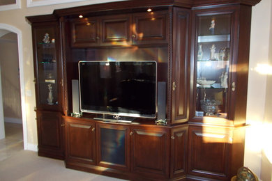 Example of a mid-sized classic enclosed carpeted and beige floor living room design in Orange County with beige walls and a media wall