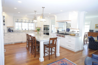 Kitchen - large transitional u-shaped medium tone wood floor and brown floor kitchen idea in Orange County with an undermount sink, beaded inset cabinets, white cabinets, granite countertops, paneled appliances and an island