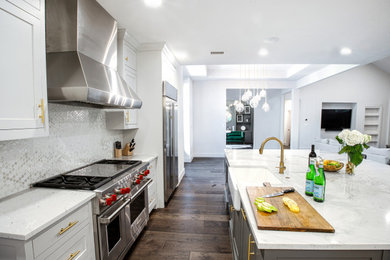 Eat-in kitchen - large mid-century modern single-wall dark wood floor and brown floor eat-in kitchen idea in Dallas with a farmhouse sink, shaker cabinets, gray cabinets, granite countertops, white backsplash, ceramic backsplash, stainless steel appliances, an island and gray countertops
