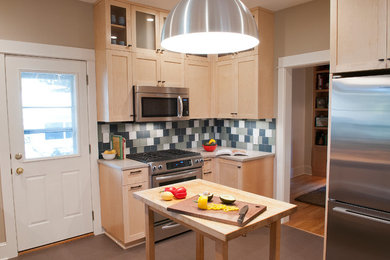 Inspiration for a mid-sized contemporary linoleum floor enclosed kitchen remodel in Portland with an undermount sink, shaker cabinets, light wood cabinets, quartzite countertops, multicolored backsplash, glass tile backsplash and stainless steel appliances