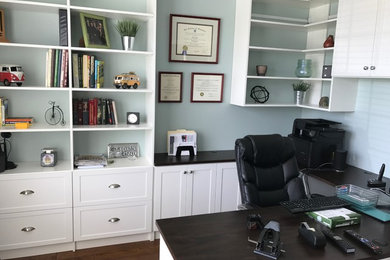 Home office - mid-sized traditional built-in desk medium tone wood floor and brown floor home office idea in Philadelphia with gray walls