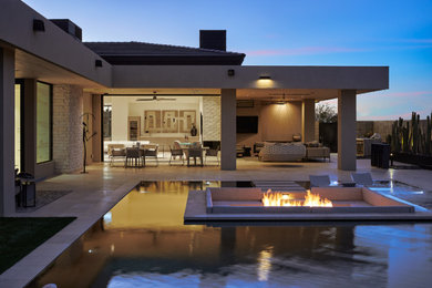 Design ideas for an expansive back patio in Phoenix with a fire feature, tiled flooring and a roof extension.