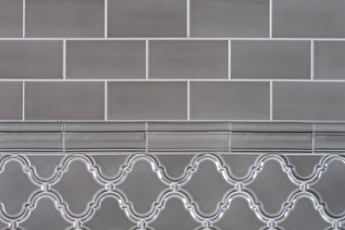 Inspiration for a gray tile and subway tile bathroom remodel in New York with gray walls