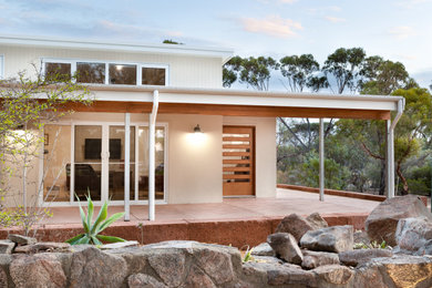 Photo of a contemporary front yard verandah in Perth with concrete slab and a roof extension.