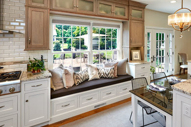 Large transitional l-shaped medium tone wood floor eat-in kitchen photo in Other with a farmhouse sink, shaker cabinets, white cabinets, granite countertops, white backsplash, porcelain backsplash, stainless steel appliances and two islands