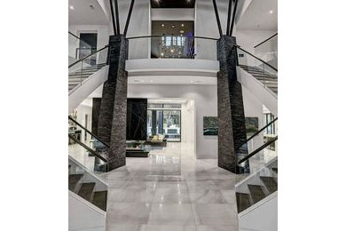 Entryway - large 1960s marble floor, gray floor, coffered ceiling and brick wall entryway idea in Other with brown walls and a yellow front door