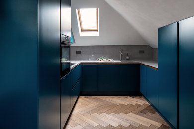 Industrial u-shaped kitchen in London with concrete worktops, grey splashback, no island and grey worktops.