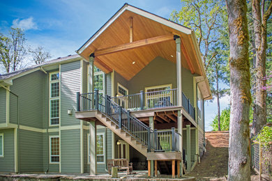 Example of a backyard patio design in Portland with decking and a roof extension