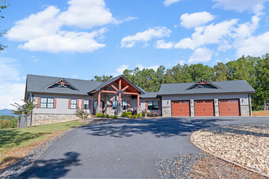 Example of an arts and crafts gray one-story exterior home design in Charlotte with a shingle roof and a gray roof