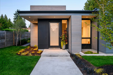 Photo of a mid-sized modern two-storey grey house exterior in Seattle with mixed siding and a flat roof.