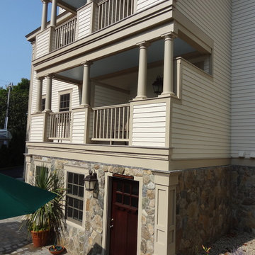 Cape Cod Inn with New England Stone Cladding, Retaining Walls, and Water Feature