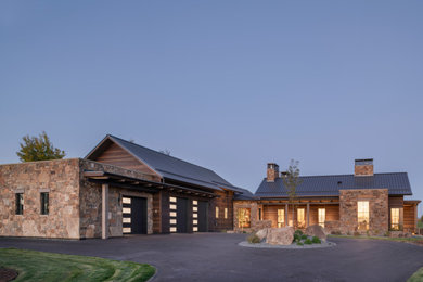 Inspiration for a large rustic brown one-story wood house exterior remodel in Other with a metal roof and a black roof