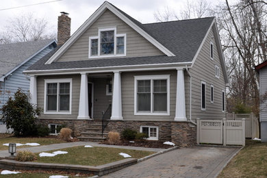 Design ideas for a mid-sized arts and crafts two-storey beige exterior in New York with mixed siding and a gable roof.