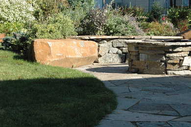 Patio - mid-sized eclectic backyard stone patio idea in Portland with a fire pit