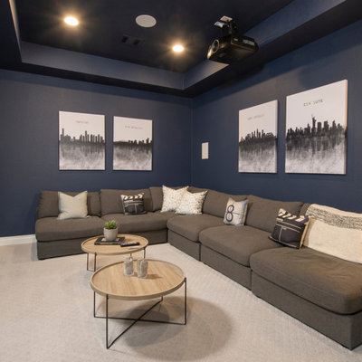 Example of an enclosed carpeted and beige floor home theater design in Houston with a projector screen and blue walls