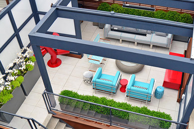 Photo of a large contemporary courtyard patio in Chicago with a gazebo/cabana and tile.