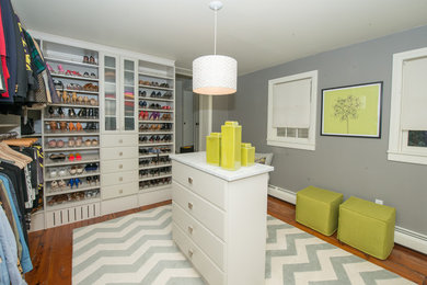 Inspiration for a large contemporary women's light wood floor dressing room remodel in Philadelphia with white cabinets and open cabinets