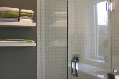 Example of a small trendy master white tile and ceramic tile ceramic tile corner shower design in Toronto with medium tone wood cabinets, a one-piece toilet, gray walls, an undermount sink, quartz countertops and recessed-panel cabinets