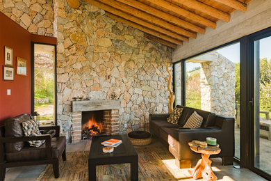 Inspiration for a small mediterranean open concept concrete floor, gray floor and exposed beam living room remodel in New York with red walls and a brick fireplace