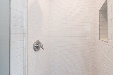 Small elegant master white tile and porcelain tile porcelain tile and brown floor alcove shower photo in DC Metro with shaker cabinets, dark wood cabinets, a two-piece toilet, gray walls, a pedestal sink and a hinged shower door