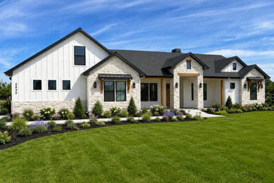 Mid-sized country white two-story mixed siding and board and batten exterior home photo in Boise with a shingle roof and a black roof