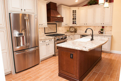 Mid-sized elegant l-shaped porcelain tile and beige floor open concept kitchen photo in Other with a farmhouse sink, raised-panel cabinets, white cabinets, granite countertops, beige backsplash, porcelain backsplash, stainless steel appliances and an island