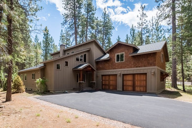 Large farmhouse brown two-story mixed siding exterior home photo in Other with a shingle roof