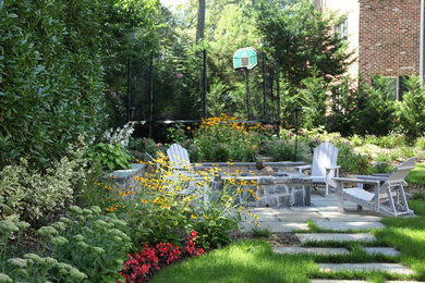 Photo of a mid-sized traditional partial sun backyard stone garden path in New York for spring.