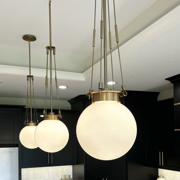 Black and Maple Wheat Kitchen with Brass Banded Hood