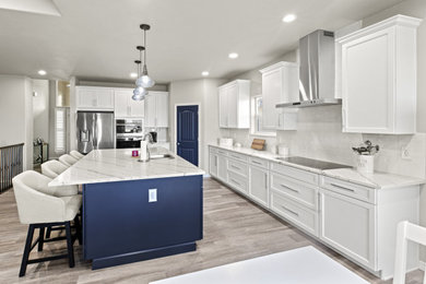 Example of a mid-sized 1950s l-shaped kitchen design in Denver with a double-bowl sink, shaker cabinets, quartz countertops, white backsplash, porcelain backsplash, stainless steel appliances and an island